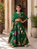 Elegant green Chinnon Chiffon 3-piece festive set with a floral top, flared lehenga and matching potli