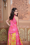Vibrant pink and green silk two-piece set featuring a printed halter top with playful tassels and a flowy palazzo