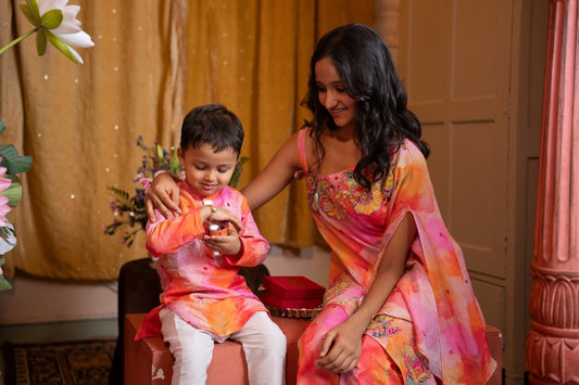 Brighten up festivities with this vibrant sibling twinning set in cheerful watercolor tones and playful embroidery. - Kirti Agarwal