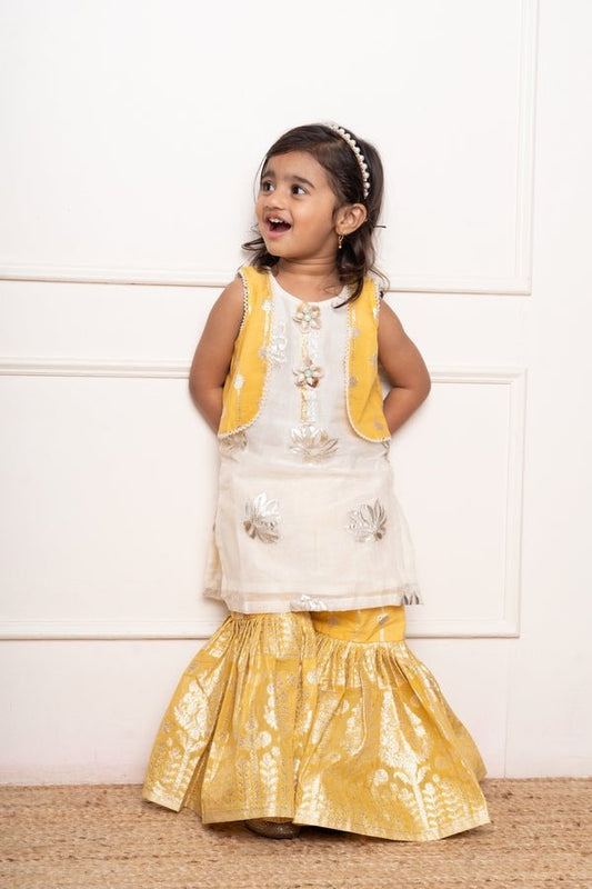 Charming ivory and yellow sharara set with delicate silver floral embroidery and playful appliqués - Kirti Agarwal