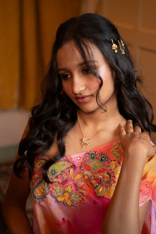 Delicate floral hairpins adorned with pearls add a graceful touch to the traditional look. - Kirti Agarwal