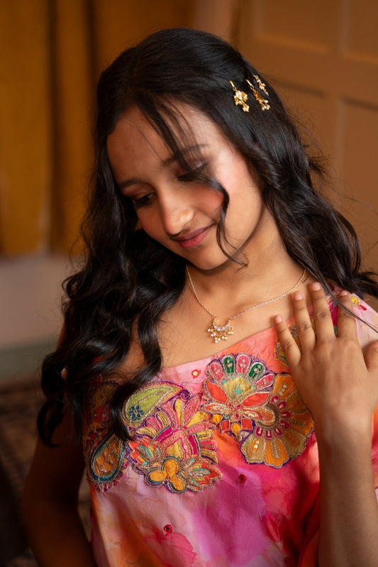 Delicate floral hairpins adorned with pearls add a graceful touch to the traditional look. - Kirti Agarwal