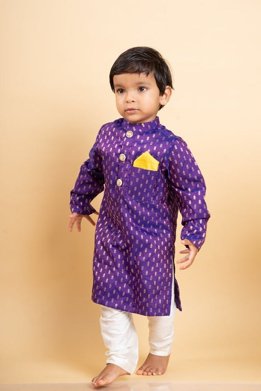 Vibrant purple kurta with golden motifs and yellow pocket square, paired with classic white churidar pants for festive elegance - Kirti Agarwal
