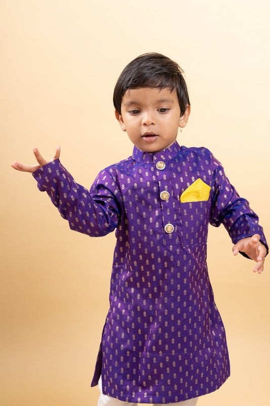 Vibrant purple kurta with golden motifs and yellow pocket square, paired with classic white churidar pants for festive elegance - Kirti Agarwal