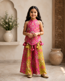 Vibrant pink and green silk two-piece set featuring a printed halter top with playful tassels and a flowy palazzo