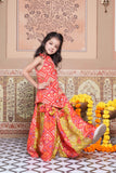 Vibrant Red and green silk two-piece set featuring a printed halter top with playful tassels and a flowy palazzo