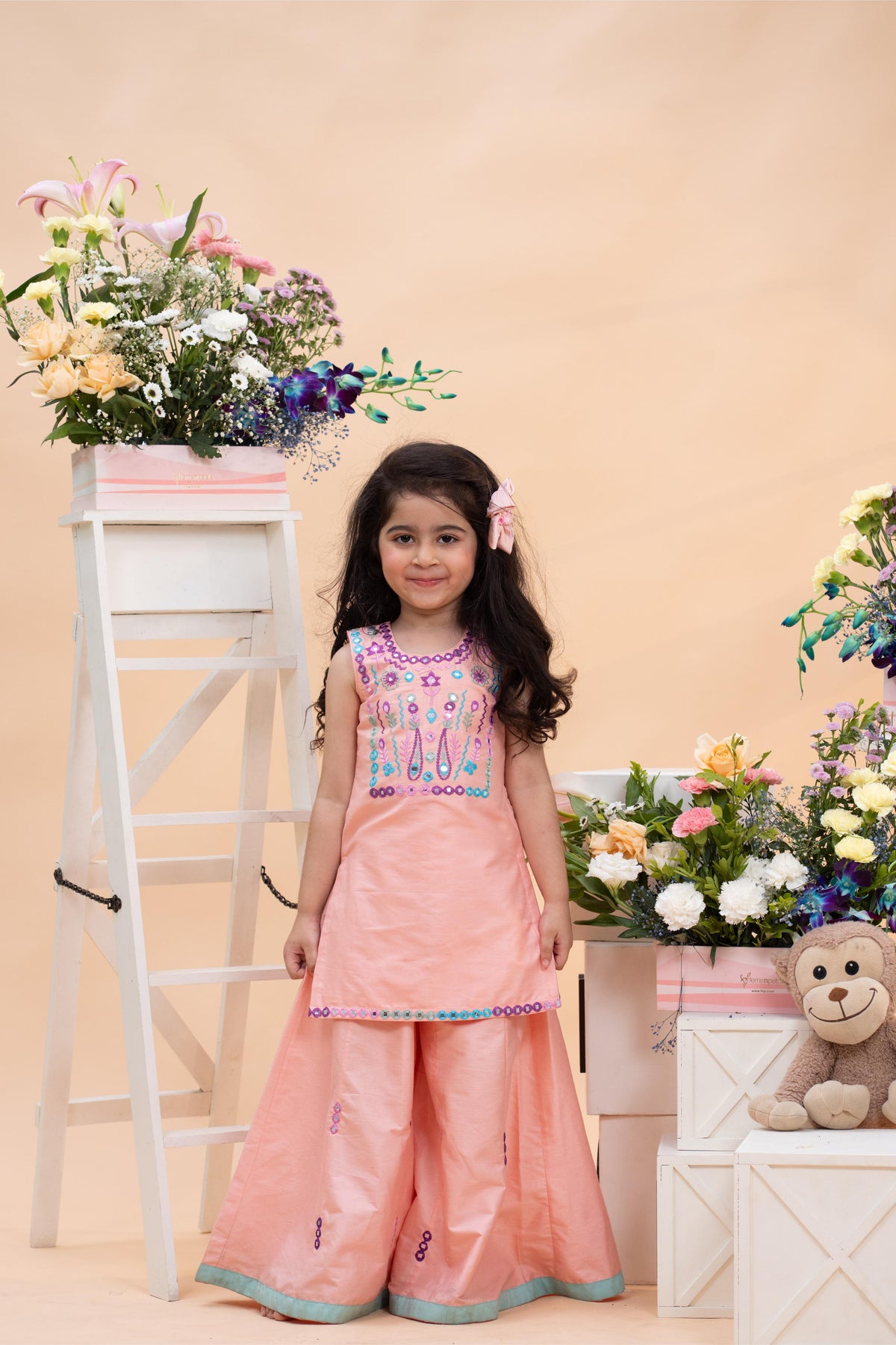 peach embroidered kurti with flared palazzo set for girls by Kirti Agarwal