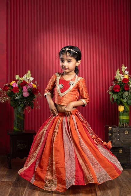 vibrant orange choli with panelled flared lehenga set for girls by Kirti Agarwal