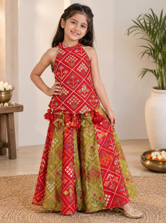 Vibrant Red and green silk two-piece set featuring a printed halter top with playful tassels and a flowy palazzo