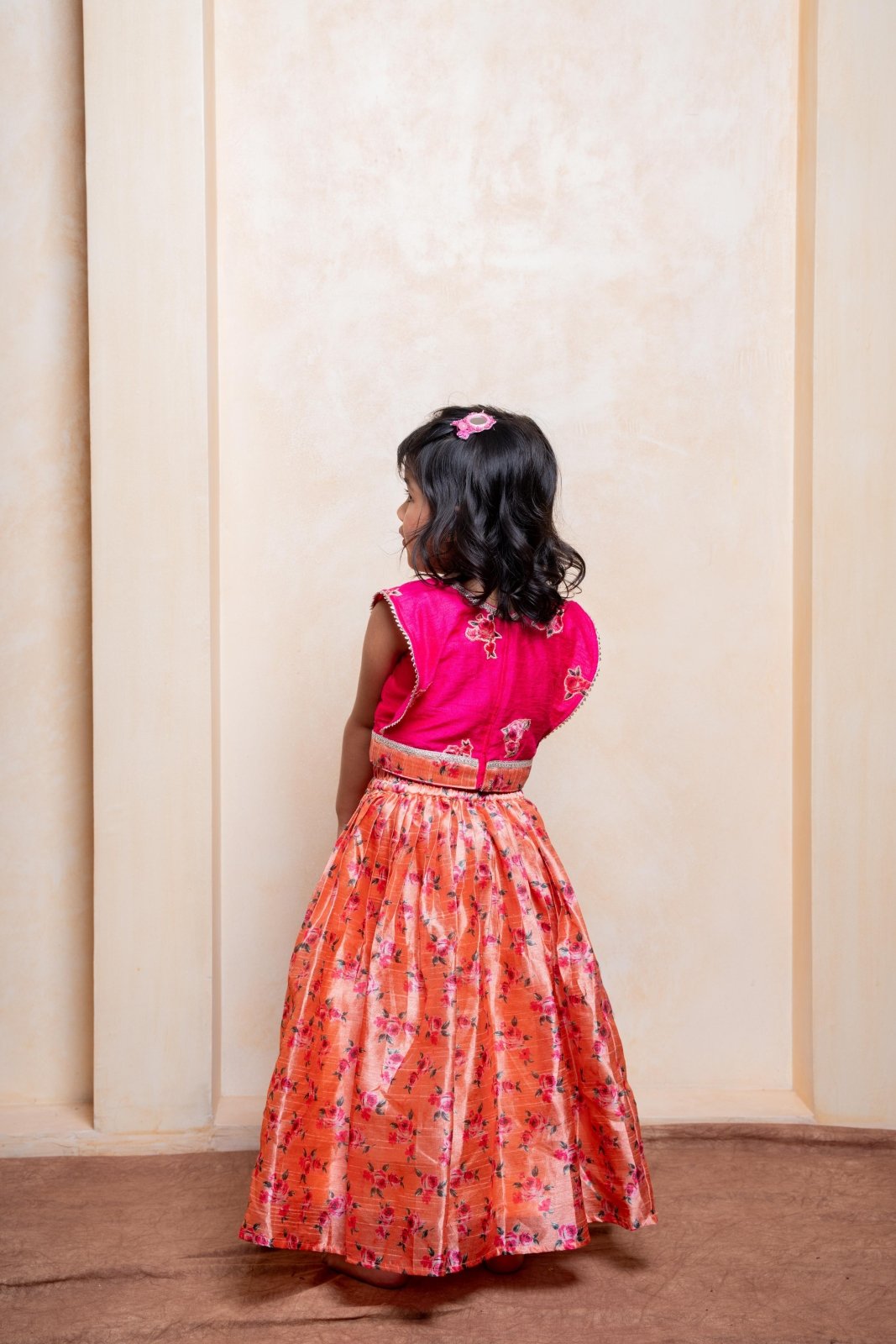 Add festive charm with this vibrant pink blouse and floral peach lehenga set for girls - Kirti Agarwal