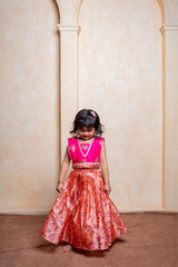 Add festive charm with this vibrant pink blouse and floral peach lehenga set for girls - Kirti Agarwal