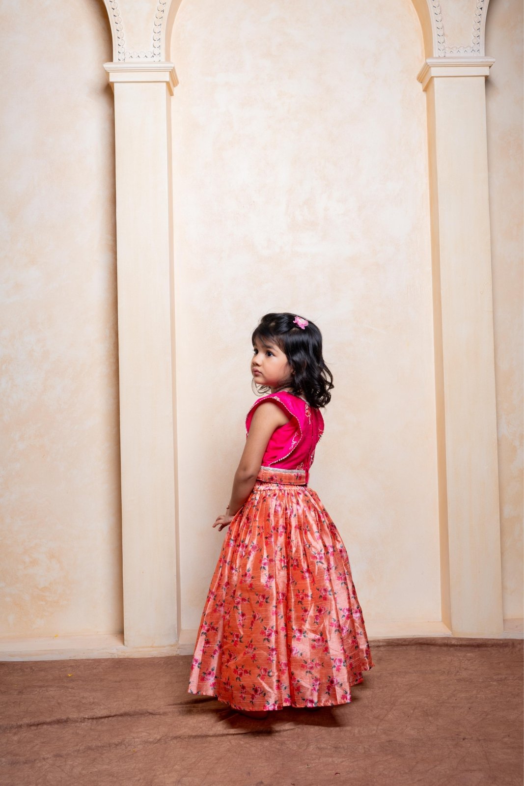 Add festive charm with this vibrant pink blouse and floral peach lehenga set for girls - Kirti Agarwal