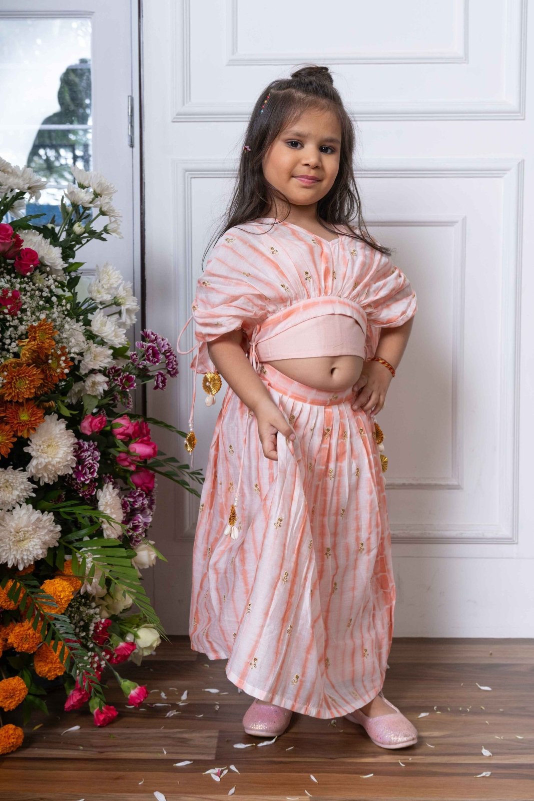 Blush Pink Lehenga Choli with Golden Embroidery and Floral Tassels for Kids - Kirti Agarwal