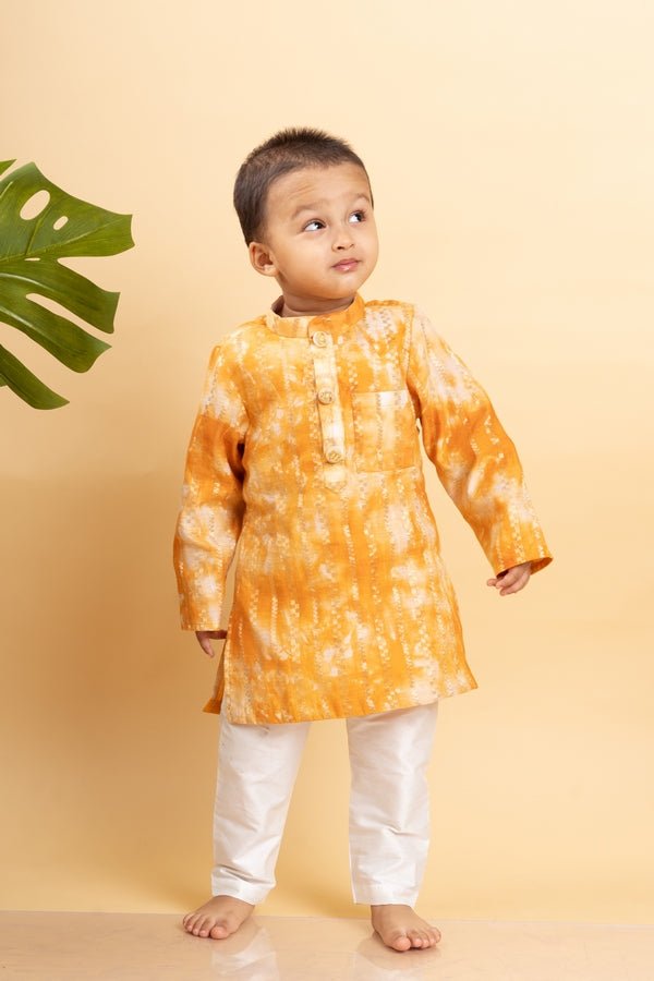 Bright orange tie - dye kurta with classic white pants for a cheerful and festive look - Kirti Agarwal