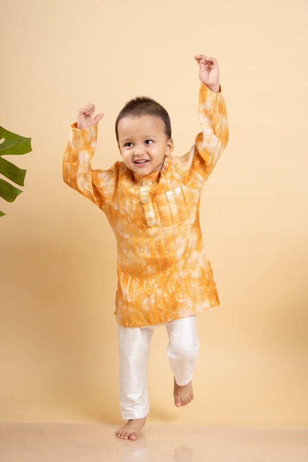 Bright orange tie - dye kurta with classic white pants for a cheerful and festive look - Kirti Agarwal