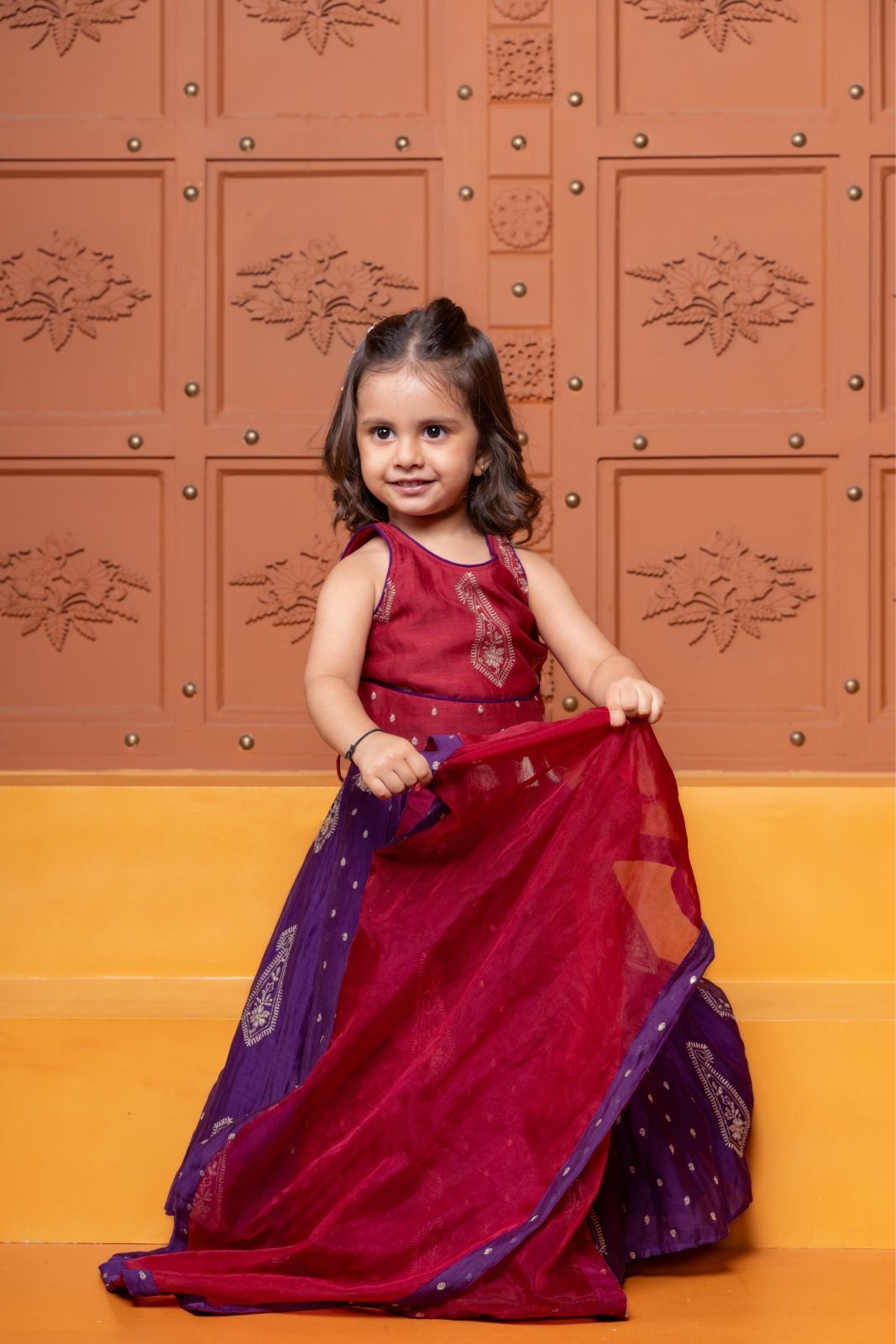 Bring festive elegance to her look with this maroon crop top and purple lehenga set for girls. - Kirti Agarwal