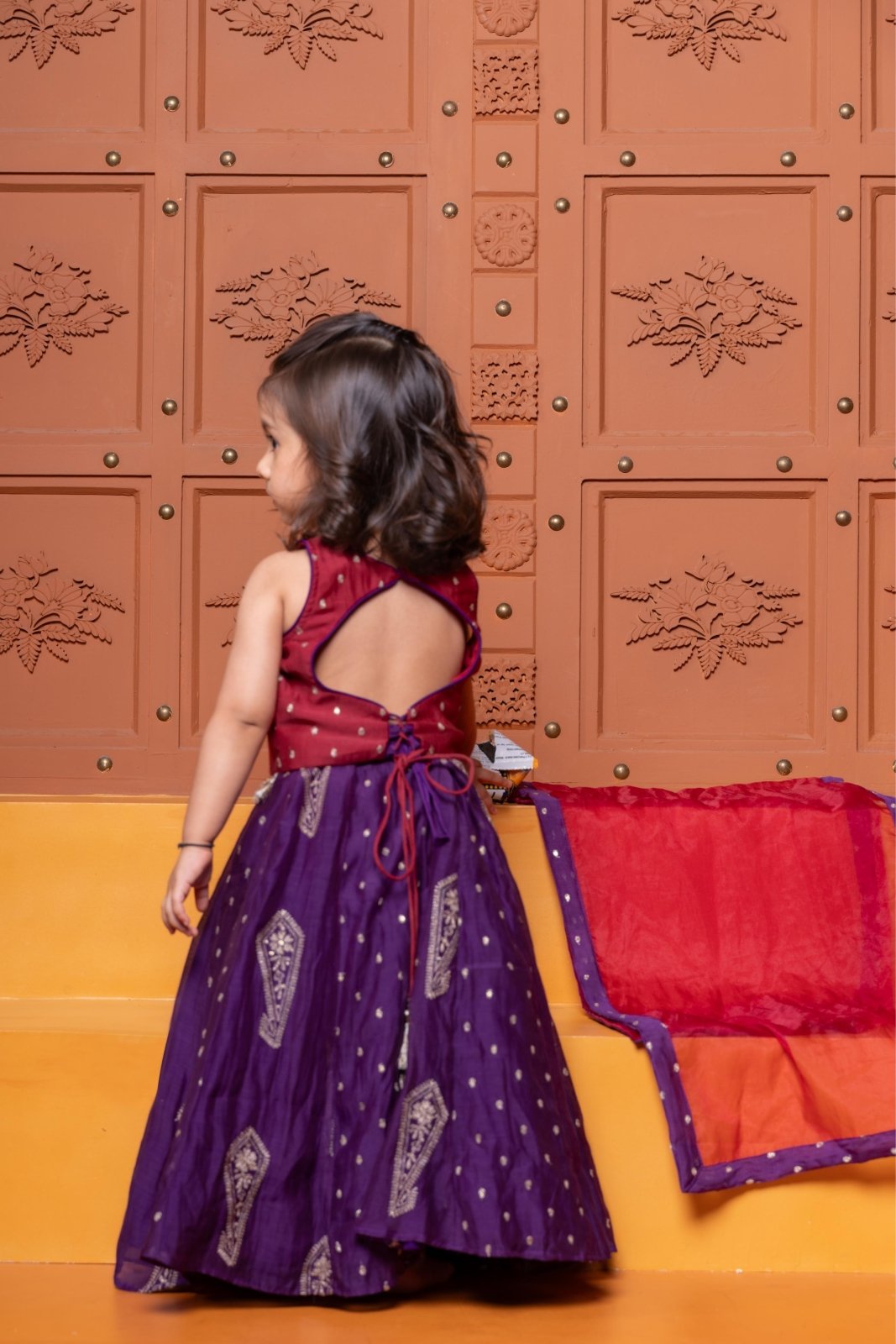 Bring festive elegance to her look with this maroon crop top and purple lehenga set for girls. - Kirti Agarwal