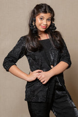 Chic black velvet ensemble with a stylish blazer and flared pants, perfect for a sophisticated and modern look at any event. - Kirti Agarwal