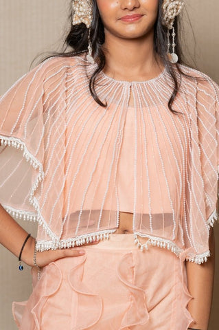 Chic Peach ensemble with beaded cape and ruffled palazzo pants, perfect for a stylish and elegant look at any occasion. - Kirti Agarwal