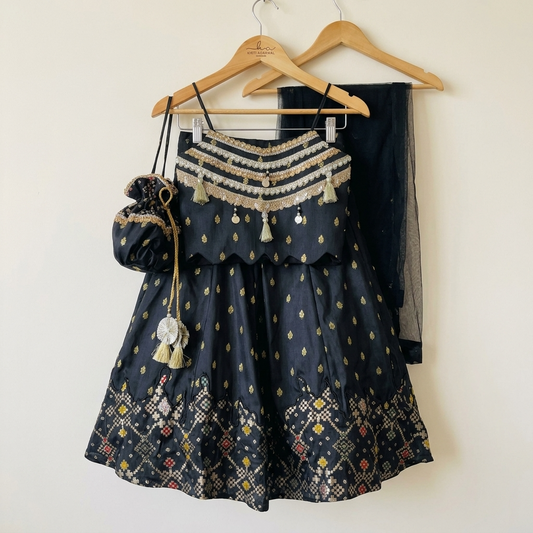 Elegant black Silk Lehenga set with rich Brocade Zari detailing, embellished crop top, dupatta and matching potli
