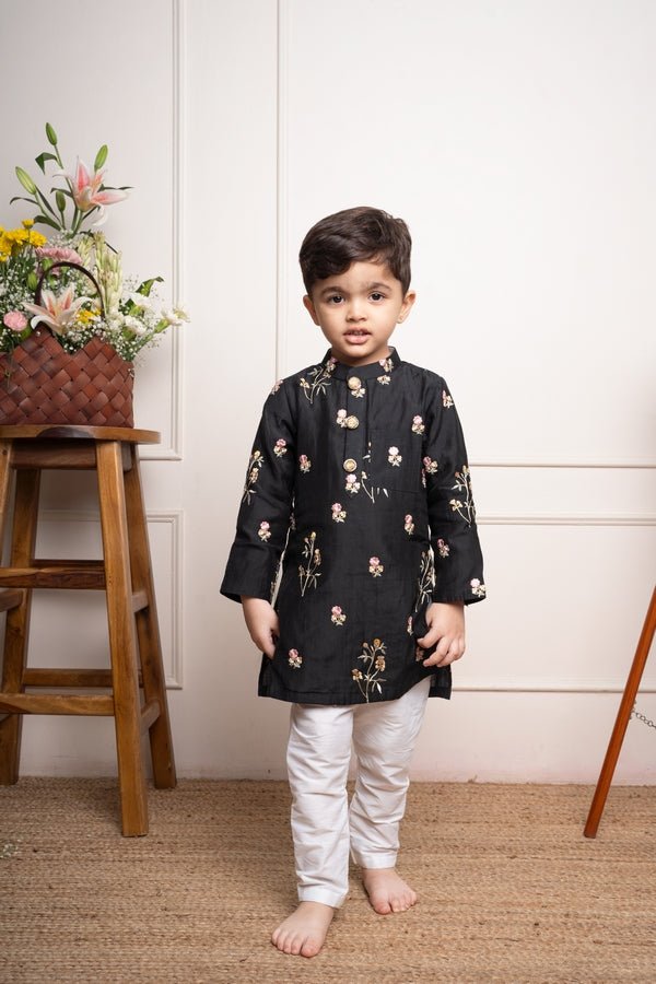 Elegant black kurta with floral embroidery paired with classic white churidar pants, perfect for festive celebrations - Kirti Agarwal