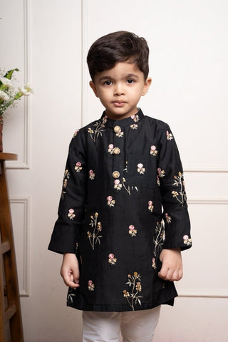 Elegant black kurta with floral embroidery paired with classic white churidar pants, perfect for festive celebrations - Kirti Agarwal