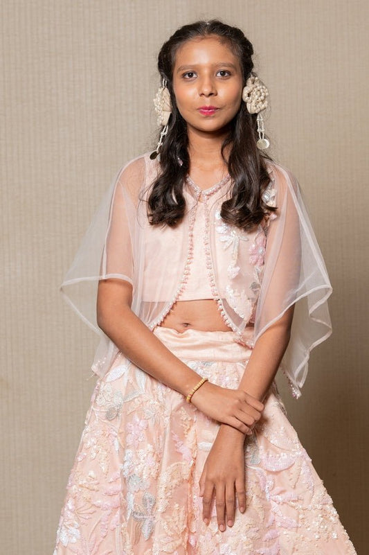 Elegant blush pink ensemble with intricate floral embroidery and a sheer overlay, perfect for any sophisticated occasion - Kirti Agarwal