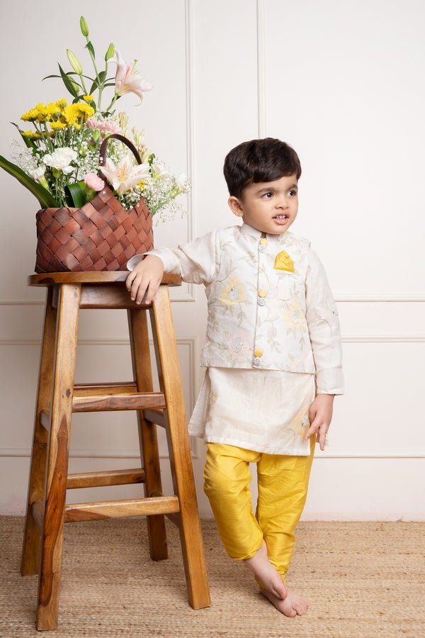 Elegant ivory kurta with matching embroidered jacket and vibrant yellow churidar pants, a stylish ensemble for festive occasions - Kirti Agarwal