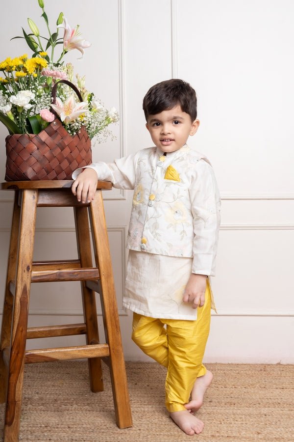 Elegant ivory kurta with matching embroidered jacket and vibrant yellow churidar pants, a stylish ensemble for festive occasions - Kirti Agarwal