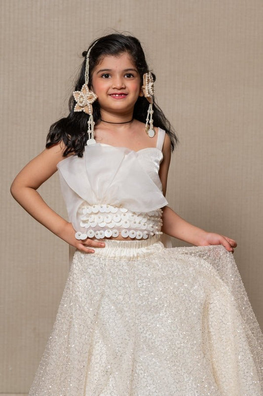 Elegant off - white crop top with a sparkling sequin Lahenga and draped bodice, perfect for a fairy - tale - inspired look at special occasions. - Kirti Agarwal