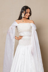 Elegant white off - the - shoulder Lahenga with intricate beadwork and flowing sleeves, perfect for a timeless and graceful look at any formal event. - Kirti Agarwal