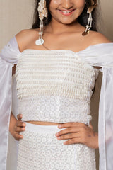 Elegant white off - the - shoulder Lahenga with intricate beadwork and flowing sleeves, perfect for a timeless and graceful look at any formal event. - Kirti Agarwal