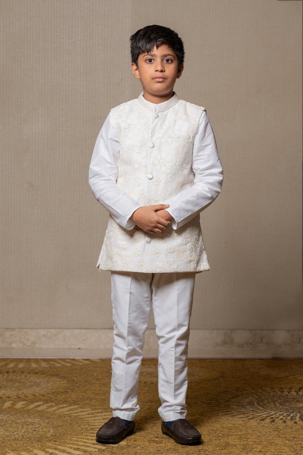 Ivory embroidered Nehru jacket paired with a classic white shirt and pants for an elegant traditional look. - Kirti Agarwal