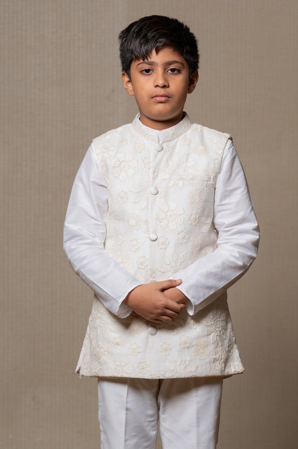 Ivory embroidered Nehru jacket paired with a classic white shirt and pants for an elegant traditional look. - Kirti Agarwal