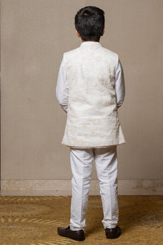 Ivory embroidered Nehru jacket paired with a classic white shirt and pants for an elegant traditional look. - Kirti Agarwal