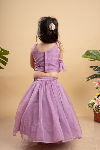 Chic Lavender lehenga with an asymmetrical top, adorned with gold and pink embellishments for a modern festive look.