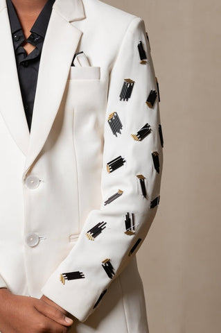 Modern off - white suit with Blackaccents and stylish embroidered sleeve detail, paired with trendy sneakers for a unique, contemporary look - Kirti Agarwal