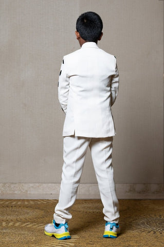 Modern off - white suit with Blackaccents and stylish embroidered sleeve detail, paired with trendy sneakers for a unique, contemporary look - Kirti Agarwal