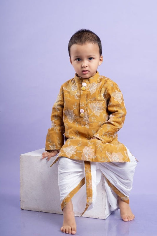 Mustard yellow embroidered kurta paired with classic white dhoti pants, perfect for festive celebrations - Kirti Agarwal