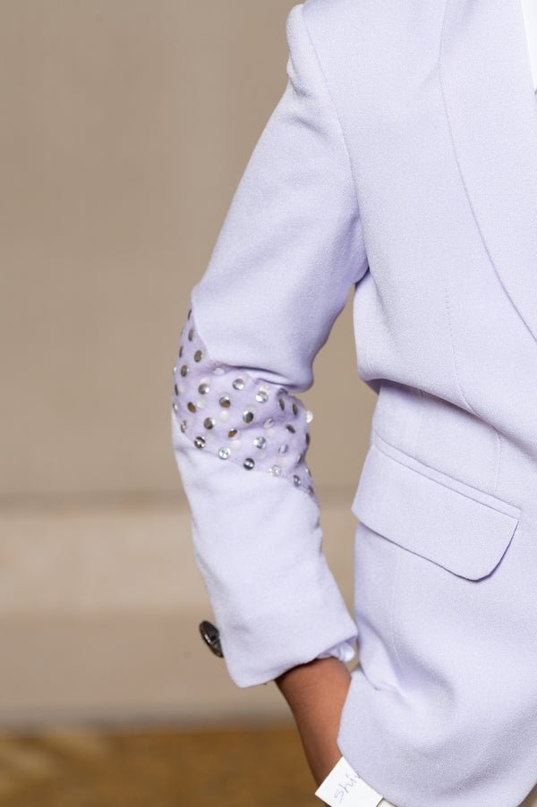 Trendy lavender blazer with metallic stud embellishments paired with classic white trousers, perfect for the modern young gentleman. - Kirti Agarwal