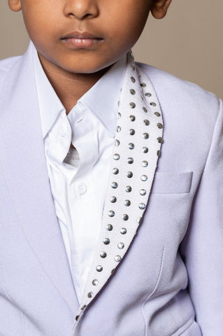 Trendy lavender blazer with metallic stud embellishments paired with classic white trousers, perfect for the modern young gentleman. - Kirti Agarwal