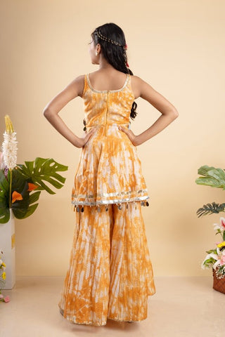 Vibrant orange tie - dye set with mirror work and tassel details, perfect for festive occasions and summer celebrations - Kirti Agarwal