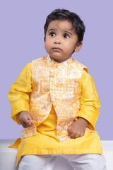 Vibrant yellow kurta set with an embroidered Peach Nehru jacket, paired with classic white churidar pants for a festive look - Kirti Agarwal