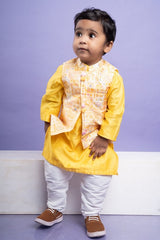 Vibrant yellow kurta set with an embroidered Peach Nehru jacket, paired with classic white churidar pants for a festive look - Kirti Agarwal